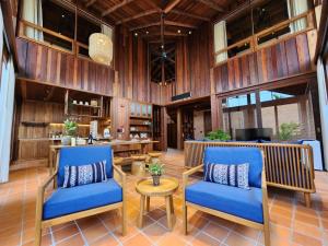 a lobby with two blue chairs and a table at Athita The Hidden Court Chiang Saen Boutique Hotel in Chiang Saen