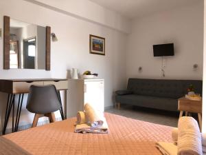 a living room with a bed and a couch at Armonia Guest House Skiathos in Skiathos Town