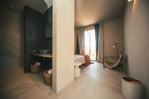 a bedroom with a bed and a sink in a room at Rakalia Pure Living Sicilian Retreat in Marsala +35 photos