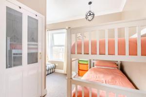 a bedroom with two bunk beds and a window at No 58 in Great Yarmouth