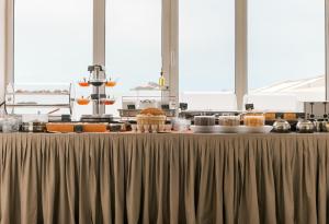 a table with food on it in a kitchen at Plaza Hotel in Loutraki