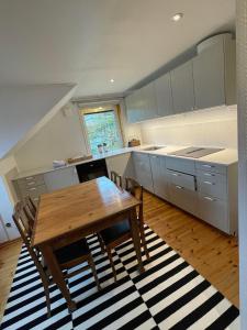 a kitchen with a wooden table and a wooden floor at Bommarvikens Bed & Breakfast in Olofström