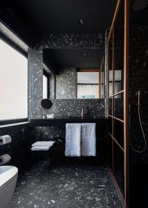 a bathroom with a sink and a toilet and a mirror at Boutique Hotel OLOM - Adults recommended in Cádiz