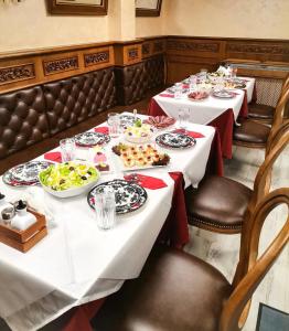 a group of tables with plates of food on them at Casa MT - Boutique Villa in Gabrovo