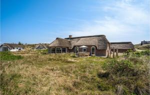 an old house in the middle of a field at Pet Friendly Home In Hvide Sande With House A Panoramic View in Havrvig