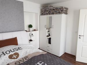 a bedroom with a bed and a dresser and a closet at Ferienwohnung Conny in Winsen