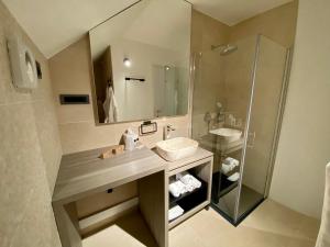 a bathroom with a sink and a shower at Boutique hotel ZBILJE in Zbilje