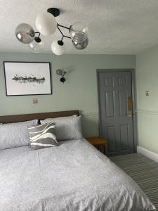 a bedroom with a bed and a ceiling fan at The Old Surgery Room Only in Scarborough