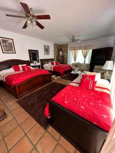 Nuevo UruapanにあるBaja best roomsの広いベッドルーム(赤いシーツを使用したベッド2台付)