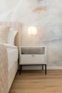 a bedroom with a bed and a table with a lamp at Apartment AURELIUS - Panoramic Views - City Center - Marjan Park - Quiet in Split