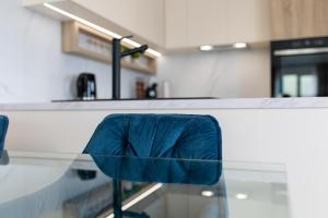 a blue chair sitting at a counter in a kitchen at Apartment Aurelius in Split
