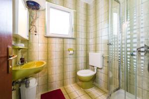 a bathroom with a toilet and a sink and a shower at Apartment Nin 531 in Nin +52 photos