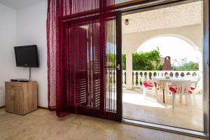 a living room with a sliding glass door to a patio at Apartment Nin 531 in Nin