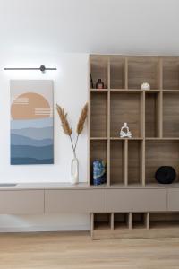 a living room with a tv on a shelf at Apartment AURELIUS - Panoramic Views - City Center - Marjan Park - Quiet in Split