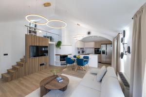 a living room with a white couch and a table at Apartment AURELIUS - Panoramic Views - City Center - Marjan Park - Quiet in Split