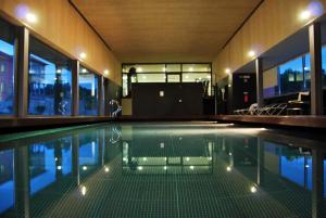 an indoor swimming pool with lights in a house at Hotel Quinta da Cruz & SPA in Ataíde