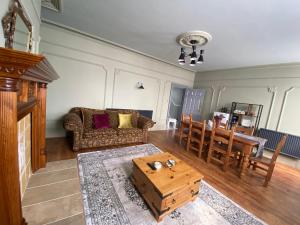 a living room with a couch and a table at The Old Surgery Room Only in Scarborough