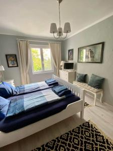 a bedroom with a large bed and a window at Fülöp Villa Apartmanház in Balatonszepezd