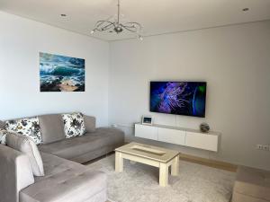 a living room with a couch and a table at Lovely 2 bedroom apartment with a great sea view in Sarandë
