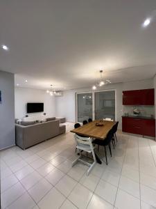 a kitchen and dining room with a table and chairs at Lovely 2 bedroom apartment with a great sea view in Sarandë
