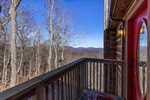 a balcony of a cabin with a view of the mountains at Cupids Retreat in Boone