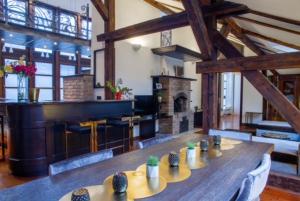 a large room with a long wooden table with plants on it at Penthouse Sky in Sarajevo