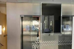 a metal elevator in a room with a mirror at Cosy Marshalls in Johannesburg