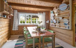 a dining room with a table and green chairs at Pet Friendly Home In Sams With Kitchen in Ballen