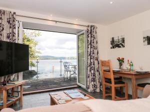 a living room with a view of the water at Spanish Boathouse in Brixham
