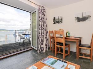 a living room with a view of the water at Spanish Boathouse in Brixham