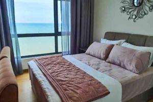 a bedroom with a large bed with a large window at Little Sunshine Place at Imperium Residence in Kuantan