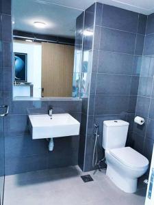 a bathroom with a white toilet and a sink at Little Sunshine Place at Imperium Residence in Kuantan +16 photos