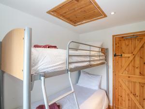 a bunk bed in a room with a wooden door at Ballyvoreen in Glandore