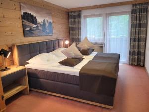 a bedroom with a large bed in a room at Haus Kohlberghof in Bichlbach