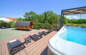 a deck with a swimming pool and a hot tub at Holiday house SEA & SUN RESIDENCE in Rasopasno