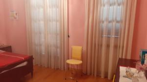 Zimmer mit gelbem Stuhl und Fenster in der Unterkunft Relais dei due Mari in Carmiano