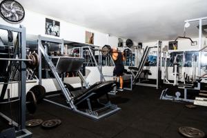 a woman doing squats in a gym with weights at Hotel Las Mercedes in Trujillo