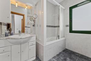 a white bathroom with a sink and a shower at Casa Mon in Costa Teguise +4 photos