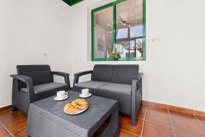 a patio with two chairs and a table with two cups at Casa Mon in Costa Teguise