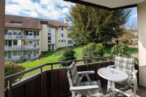 a balcony with a table and chairs and a building at Fewo Schneckenhalde App 12 in Bad Säckingen