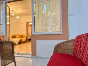 a living room with two chairs and a window at Seashell Holiday Studios in Ermioni