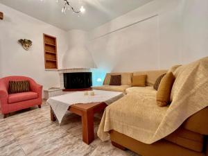 a living room with a couch and a fire place at Seashell Holiday Studios in Ermioni