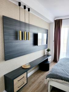 a bedroom with a desk and a mirror on the wall at Double room - House of Chess in Satu Mare