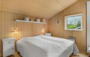 a bedroom with a white bed and a window at Awesome Home In Ebeltoft With Kitchen in Ebeltoft