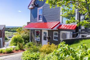 a house with red awnings on it at Hillside Motel in Saint John