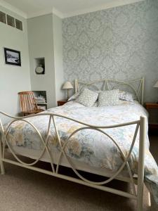 a bedroom with a bed with a metal frame at Westley B&B in Uplyme