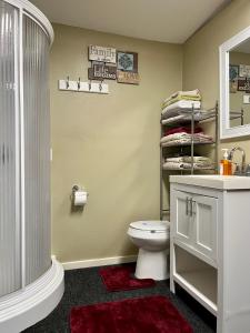 a bathroom with a toilet and a sink and a shower at Casita with Swimming Pond & Sand Volleyball Access in Montgomery +8 photos