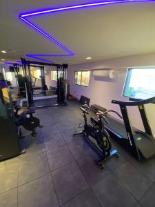 a gym with treadmills and ellipticals in a room at Arpoar Suítes - Suíte 433 in João Pessoa