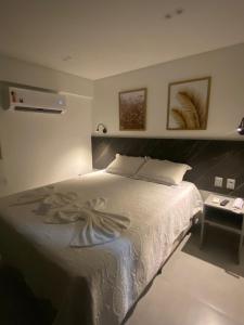 1 dormitorio con 1 cama grande y 1 mesa en Arpoar Suítes - Suíte 433 en João Pessoa