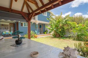 a patio with a table in front of a house at Villa Sun and Sea in Deshaies
